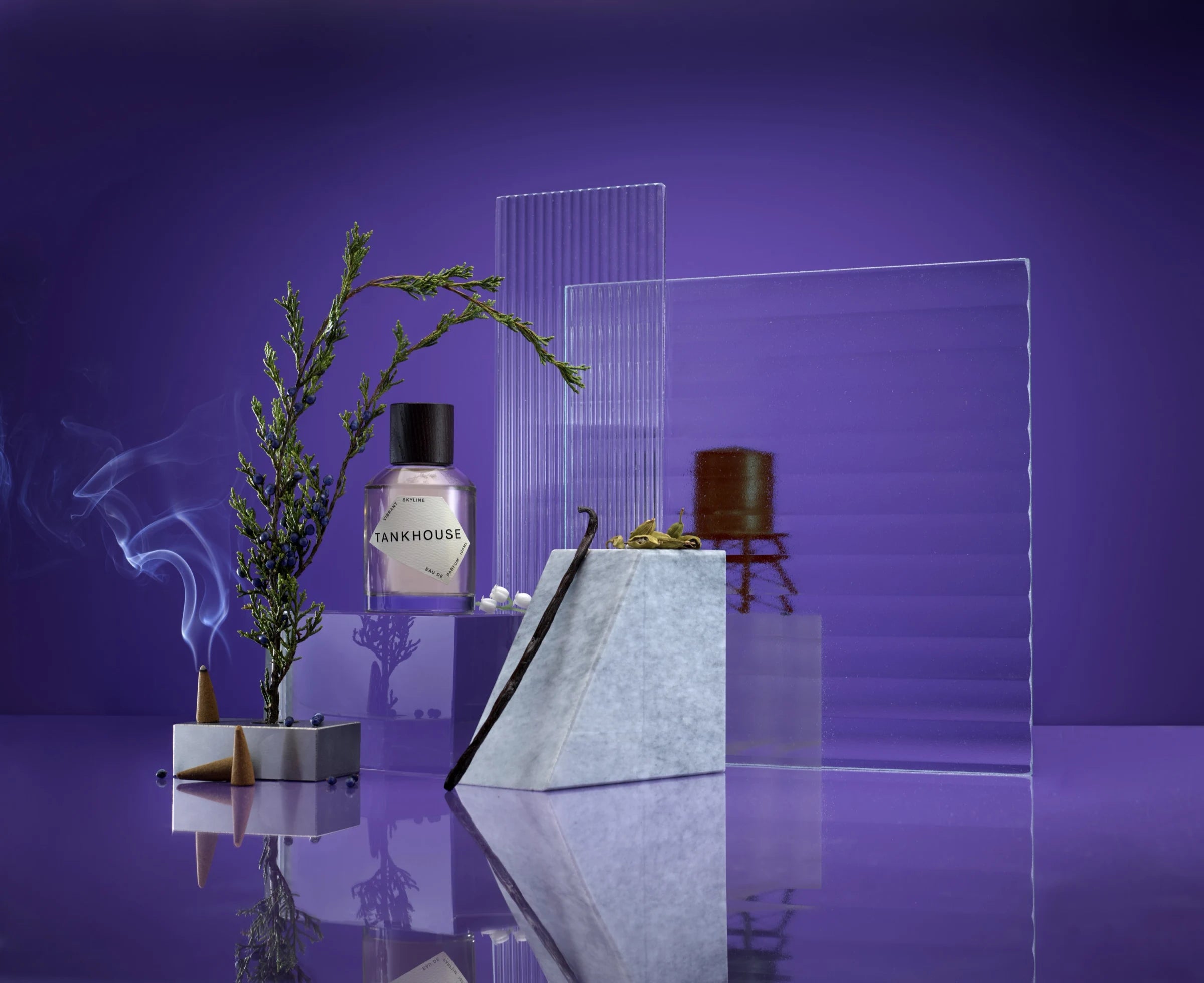Vibrant Skyline bottle staged with glass, botanicals, smoke, and a wooden water tower form
